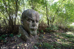 A statue of Lenin in the woods